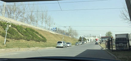 view of road with clear skies from back window of car