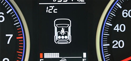 closeup of car dashboard with engine oil topup warning