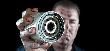 mechanic holding oil filter