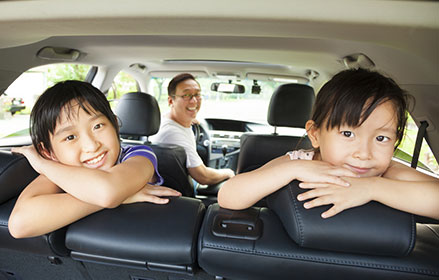 two girls, arms crossed, back-seat, family with road and trip